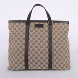 Beige GG canvas tote bag with brown leather handles and trim, featuring signature monogram pattern — Gucci | Endless UAE