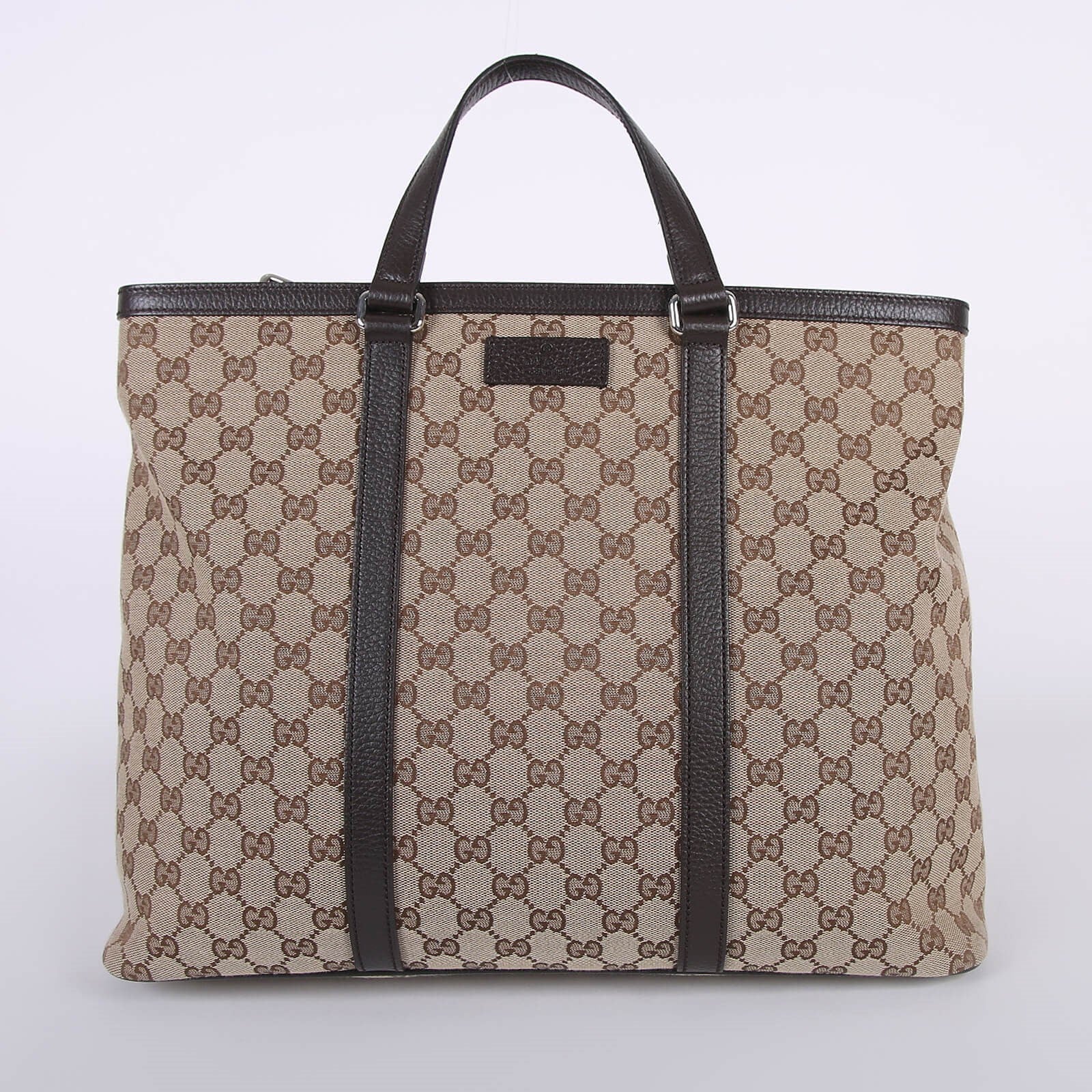 Beige GG canvas tote bag with brown leather handles and trim, featuring signature monogram pattern — Gucci | Endless UAE