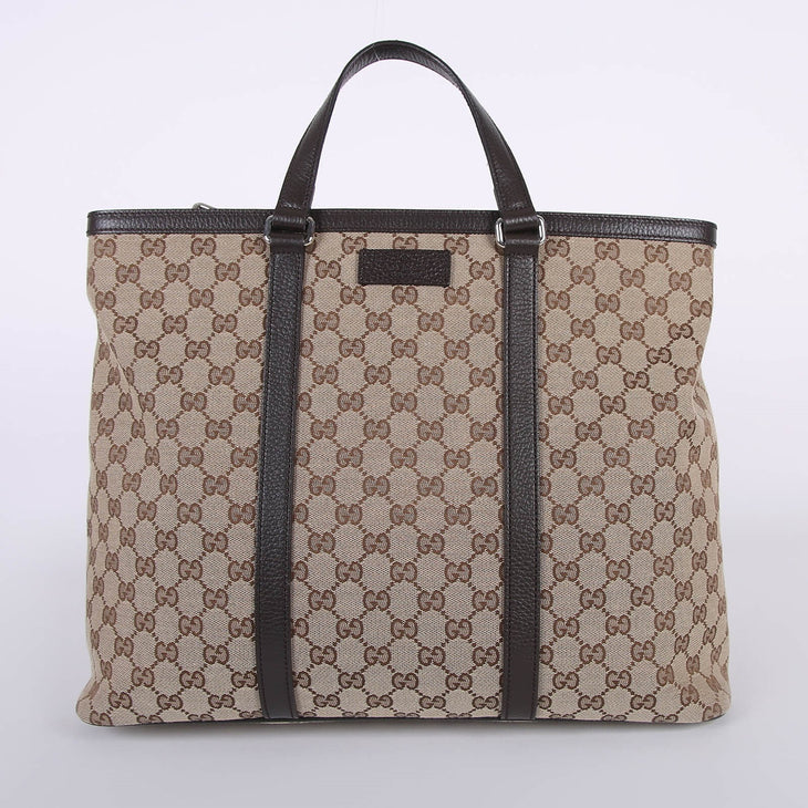 Beige GG canvas tote bag with brown leather handles and trim, featuring signature monogram pattern — Gucci | Endless UAE