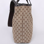 Beige GG canvas tote bag with brown leather trim and shoulder strap, side view showing monogram pattern — Gucci | Endless UAE