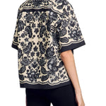 Floral print short sleeve shirt with scalloped trim and baroque pattern in black and beige — Sandro | Endless UAE
