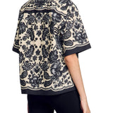 Floral print short sleeve shirt with scalloped trim and baroque pattern in black and beige — Sandro | Endless UAE