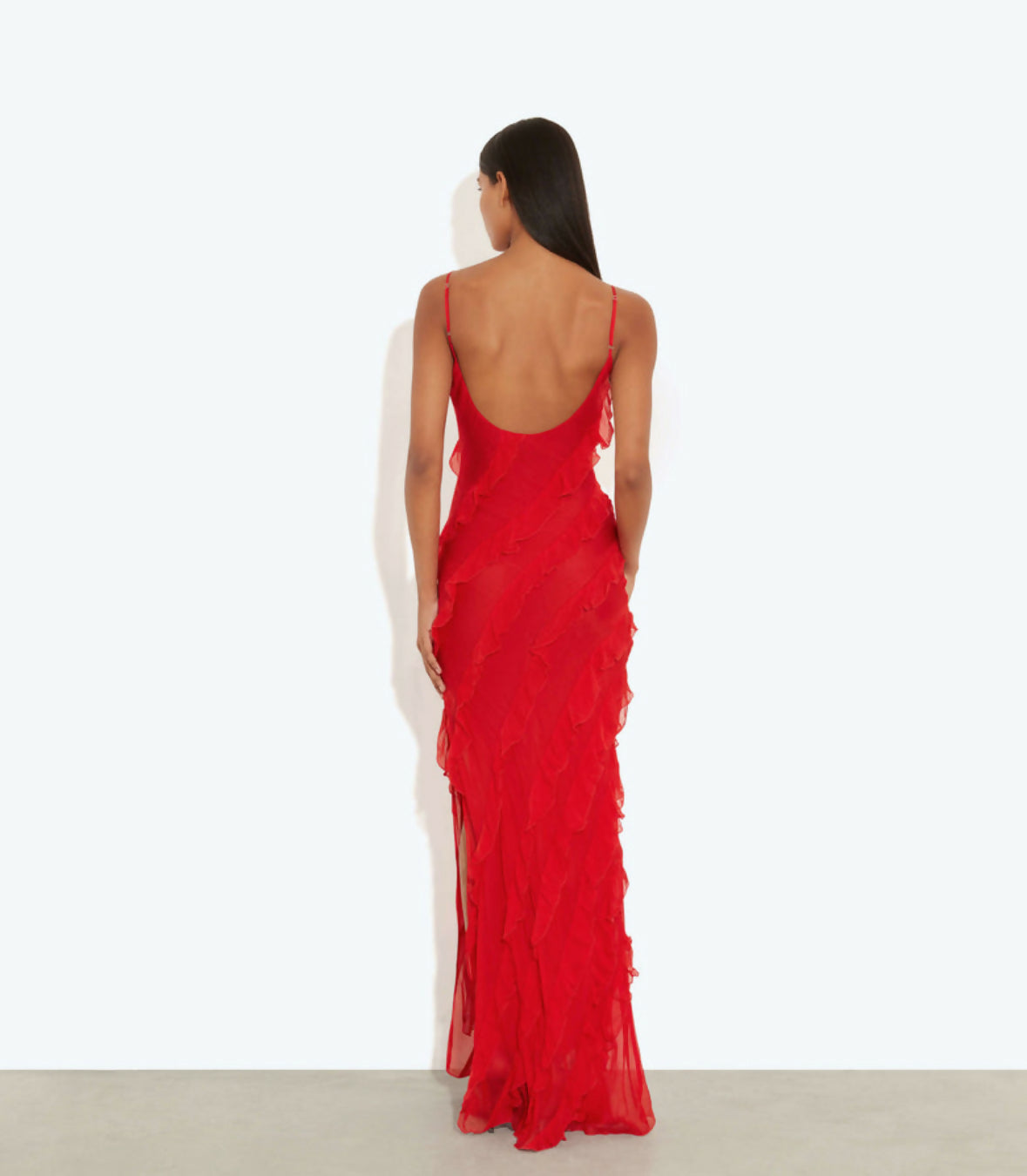 Back view of woman wearing floor-length red textured gown with thin straps and open back — Rat & Boa | Endless UAE