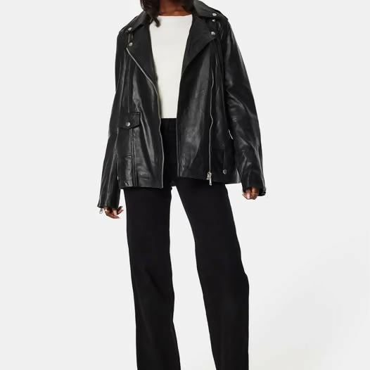 Black oversized leather biker jacket with notch lapels and zippered pockets styled with white tee and black trousers — Selected Femme | Endless UAE