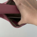 Pink leather mini shoulder bag with dual handles displayed against neutral background — By Far | Endless UAE