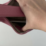 Pink leather mini shoulder bag with dual handles displayed against neutral background — By Far | Endless UAE