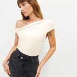 Woman wearing cream off-shoulder Cello Knit Top with black denim skirt and nude heels — Reformation | Endless UAE