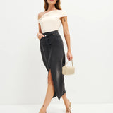 Woman wearing cream off-shoulder Cello Knit Top with black denim skirt and nude heels — Reformation | Endless UAE