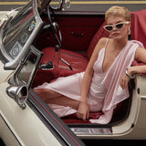 Elegant pink backless dress worn by model in vintage convertible car — By Keara | Endless UAE