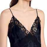 Black satin slip dress with ornate lace trim detailing on neckline and thin adjustable shoulder straps — Sandro | Endless UAE