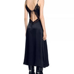 Black satin slip dress with ornate lace cutout back detail and adjustable straps, worn with leather boots — Sandro | Endless UAE