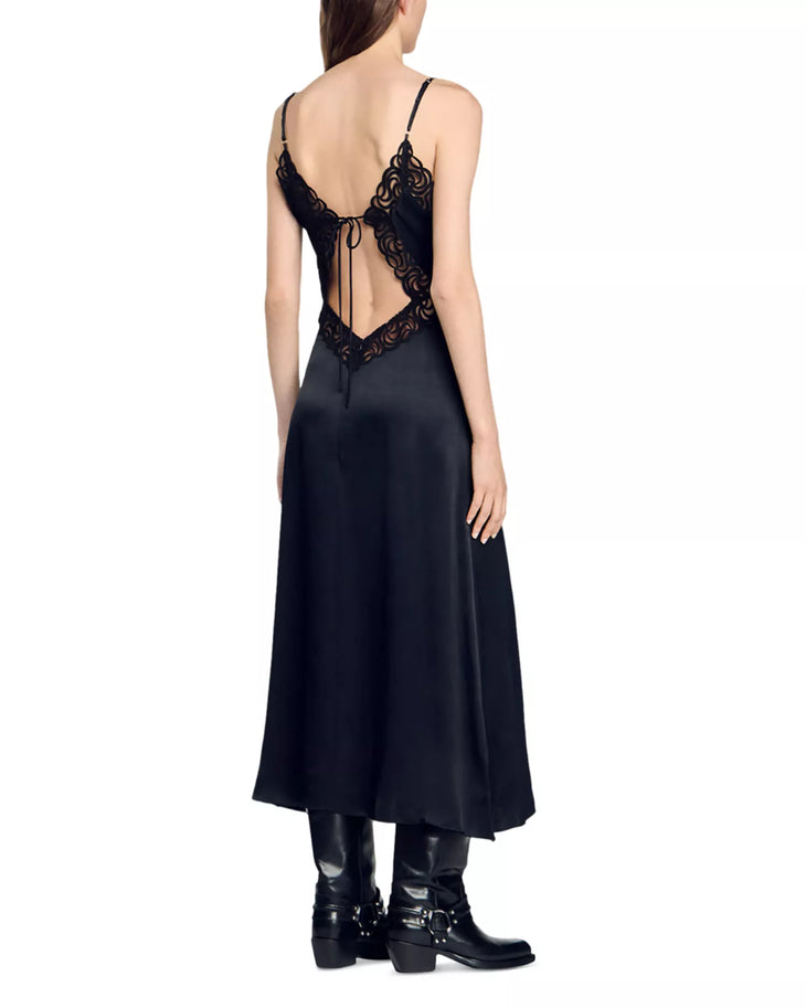 Black satin slip dress with ornate lace cutout back detail and adjustable straps, worn with leather boots — Sandro | Endless UAE