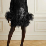 Black feather-trimmed devore dress with high neckline on model — Taller Marmo | Endless UAE
