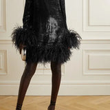 Black feather-trimmed devore dress with high neckline on model — Taller Marmo | Endless UAE