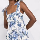 Woman wearing white and blue floral-print sleeveless dress with tie shoulder straps and empire waist — Zimmermann | Endless UAE