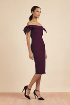 Woman wearing burgundy off-shoulder pencil dress with tie sleeves — The Pretty Dress Company | Endless UAE