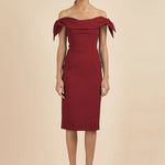 Woman wearing burgundy off-shoulder Tilly Pencil Dress with tied sleeves and black heels — The Pretty Dress Company | Endless UAE