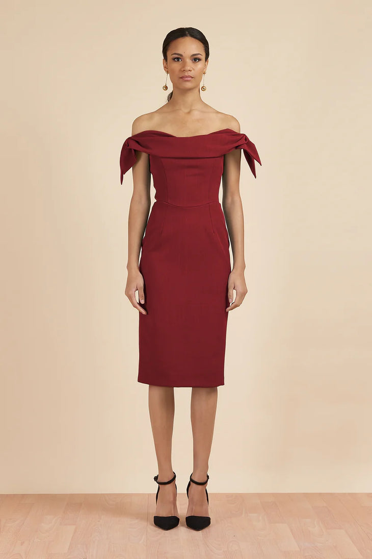 Woman wearing burgundy off-shoulder Tilly Pencil Dress with tied sleeves and black heels — The Pretty Dress Company | Endless UAE