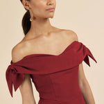 Woman wearing burgundy off-shoulder Tilly Pencil Dress with tied sleeves and black heels — The Pretty Dress Company | Endless UAE