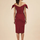 Woman wearing burgundy off-shoulder Tilly Pencil Dress with tied sleeves and black heels — The Pretty Dress Company | Endless UAE