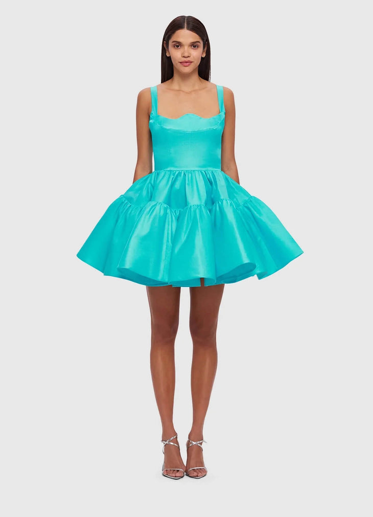 Woman wearing a turquoise structured mini dress with sweetheart neckline and full skirt — Leo Lin | Endless UAE