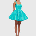Woman wearing a turquoise structured mini dress with sweetheart neckline and full skirt — Leo Lin | Endless UAE