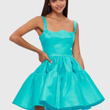 Woman wearing a turquoise structured mini dress with sweetheart neckline and full skirt — Leo Lin | Endless UAE