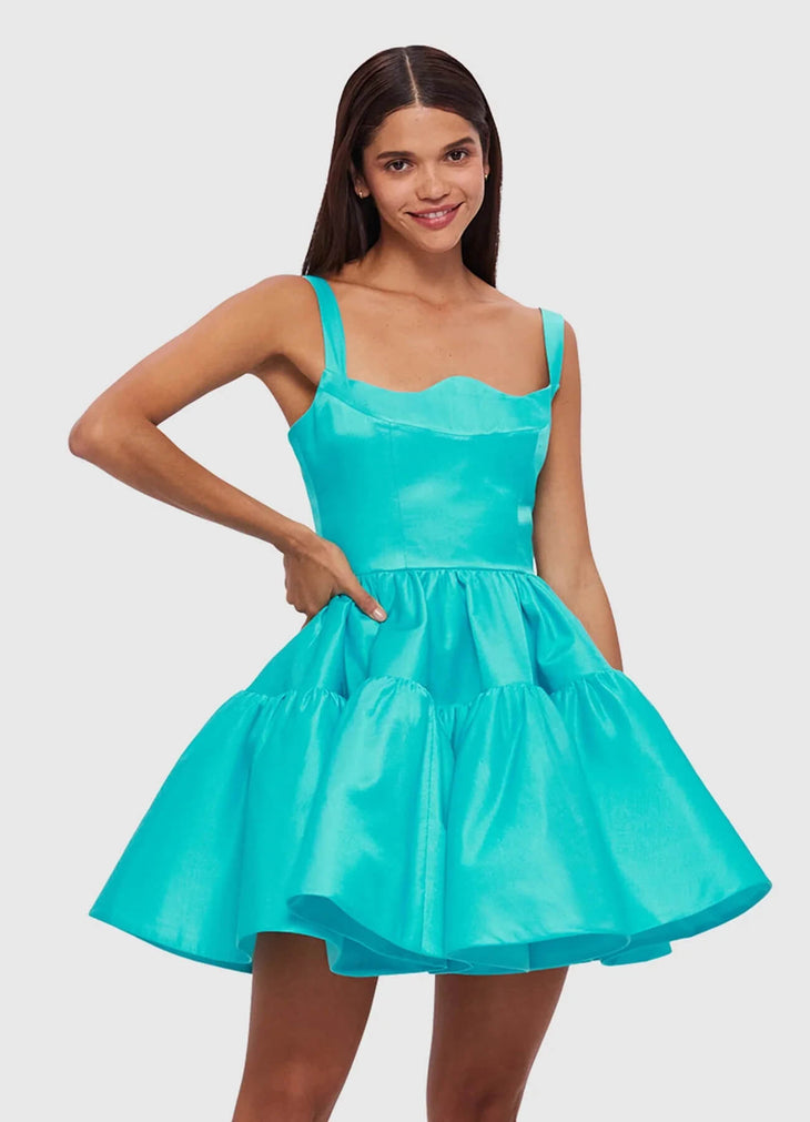 Woman wearing a turquoise structured mini dress with sweetheart neckline and full skirt — Leo Lin | Endless UAE