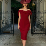 Woman wearing burgundy off-shoulder Tilly Pencil Dress with tied sleeves and black heels — The Pretty Dress Company | Endless UAE