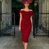Woman wearing burgundy off-shoulder Tilly Pencil Dress with tied sleeves and black heels — The Pretty Dress Company | Endless UAE