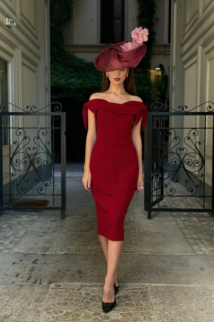 Woman wearing burgundy off-shoulder Tilly Pencil Dress with tied sleeves and black heels — The Pretty Dress Company | Endless UAE