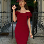 Woman wearing burgundy off-shoulder Tilly Pencil Dress with tied sleeves and black heels — The Pretty Dress Company | Endless UAE