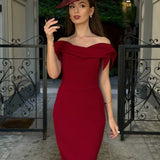 Woman wearing burgundy off-shoulder Tilly Pencil Dress with tied sleeves and black heels — The Pretty Dress Company | Endless UAE