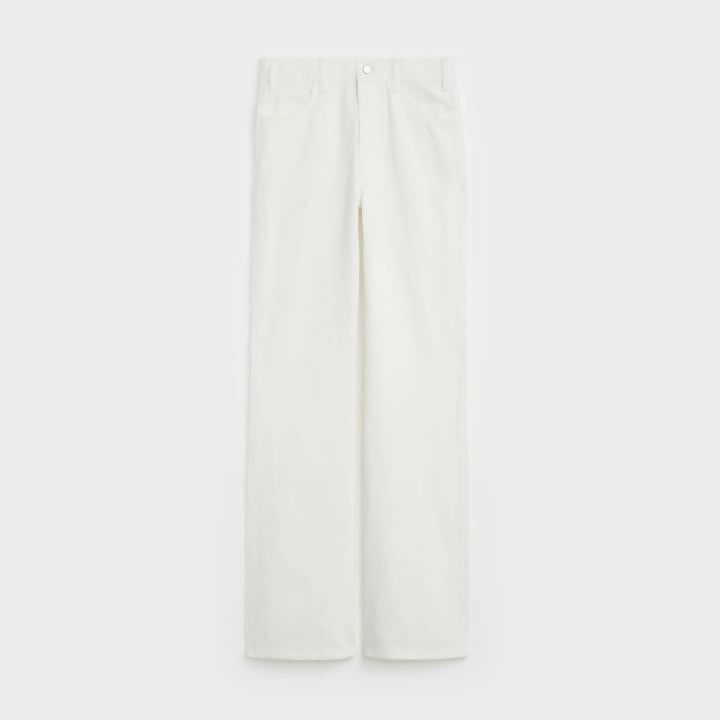 Folded white denim jeans with visible back pocket detail — Celine | Endless UAE