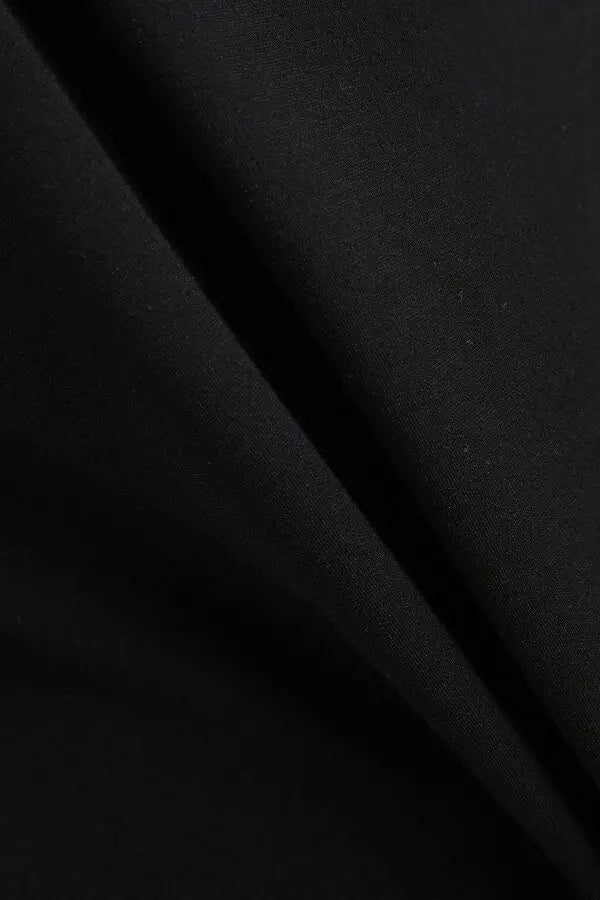 Black stretch-jersey fabric with subtle texture and draping detail — Moschino | Endless UAE