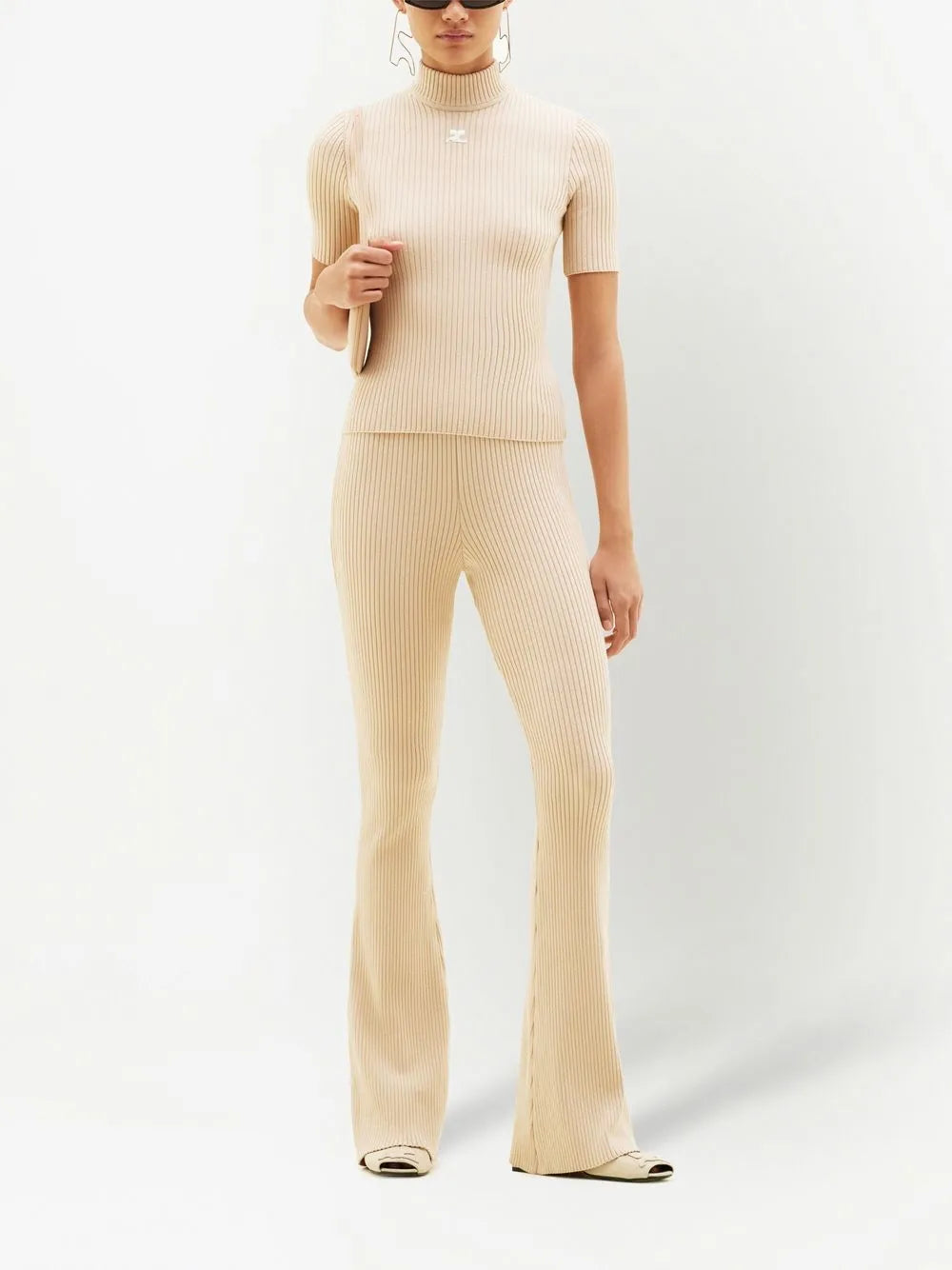 Cream ribbed knit flare pants with high waist and fitted silhouette — Courrēges | Endless UAE