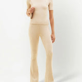 Cream ribbed knit flare pants with high waist and fitted silhouette — Courrēges | Endless UAE