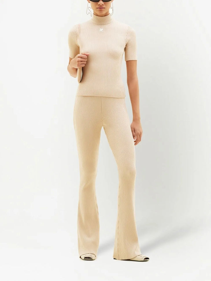 Cream ribbed knit flare pants with high waist and fitted silhouette — Courrēges | Endless UAE