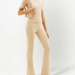 Cream ribbed knit flare pants with high waist and fitted silhouette — Courrēges | Endless UAE