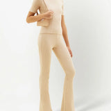 Cream ribbed knit flare pants with high waist and fitted silhouette — Courrēges | Endless UAE