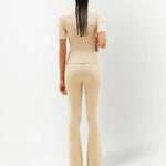 Cream ribbed knit flare pants with high waist and fitted silhouette — Courrēges | Endless UAE