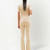 Cream ribbed knit flare pants with high waist and fitted silhouette — Courrēges | Endless UAE