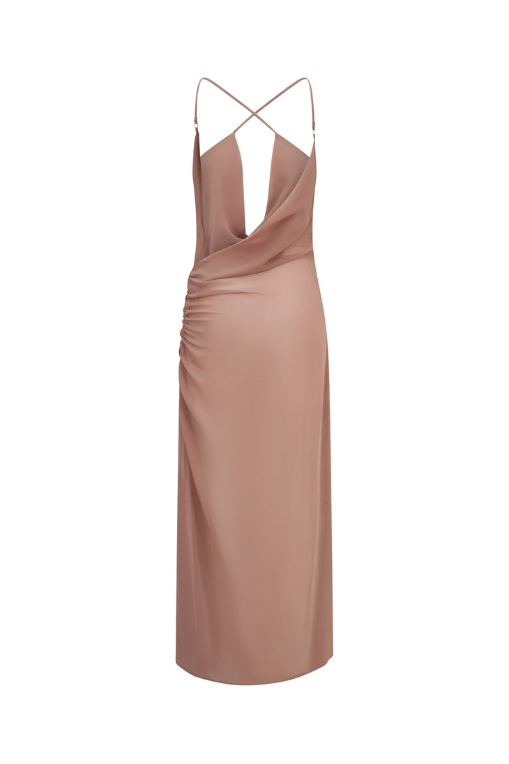 Woman wearing dusty rose Gaia Maxi Dress by a serene alpine lake with mountains — Scorpio Rizing | Endless UAE
