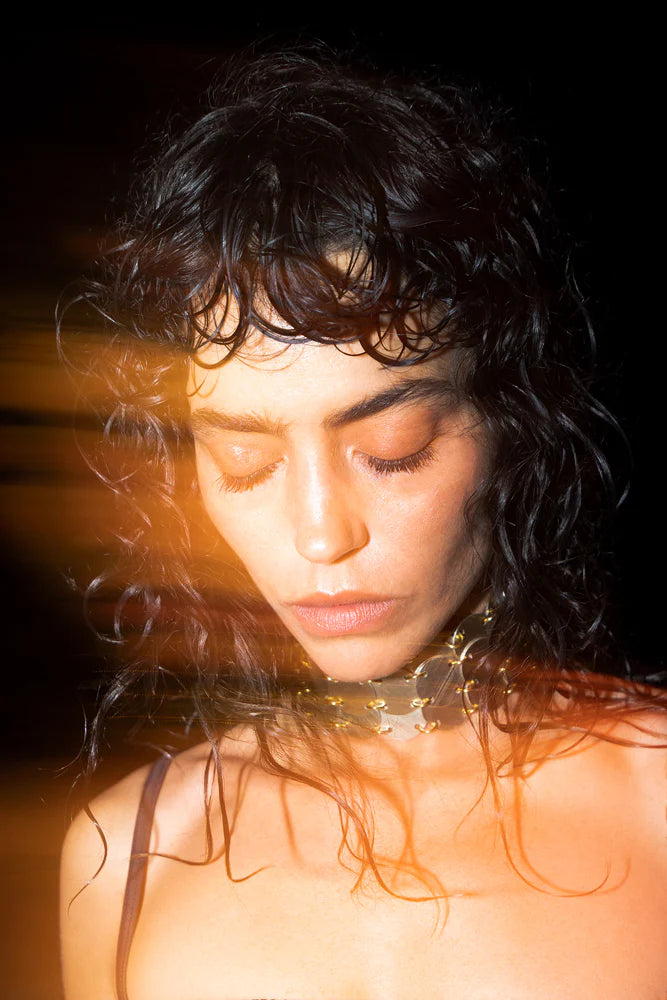 Gold chain link choker necklace on model with dark curly hair — Isabel Moore | Endless UAE