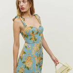 Floral print mini dress with tie shoulder straps and fitted bodice in blue with yellow blooms — Reformation | Endless UAE