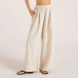 Woman wearing cream linen blend strapless blouse and wide-leg pants — Leo Lin | Endless UAE