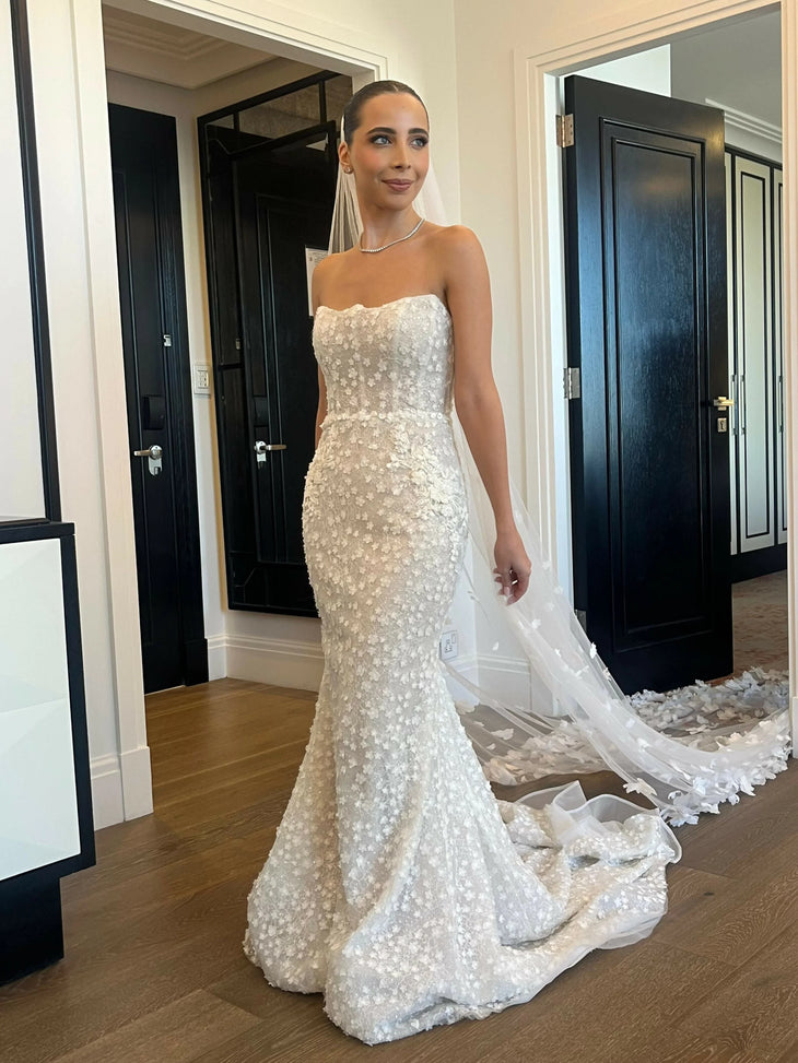 Alaia bridal gown featuring beaded bodice and flowing tulle train on beach — Wona Concept | Endless UAE