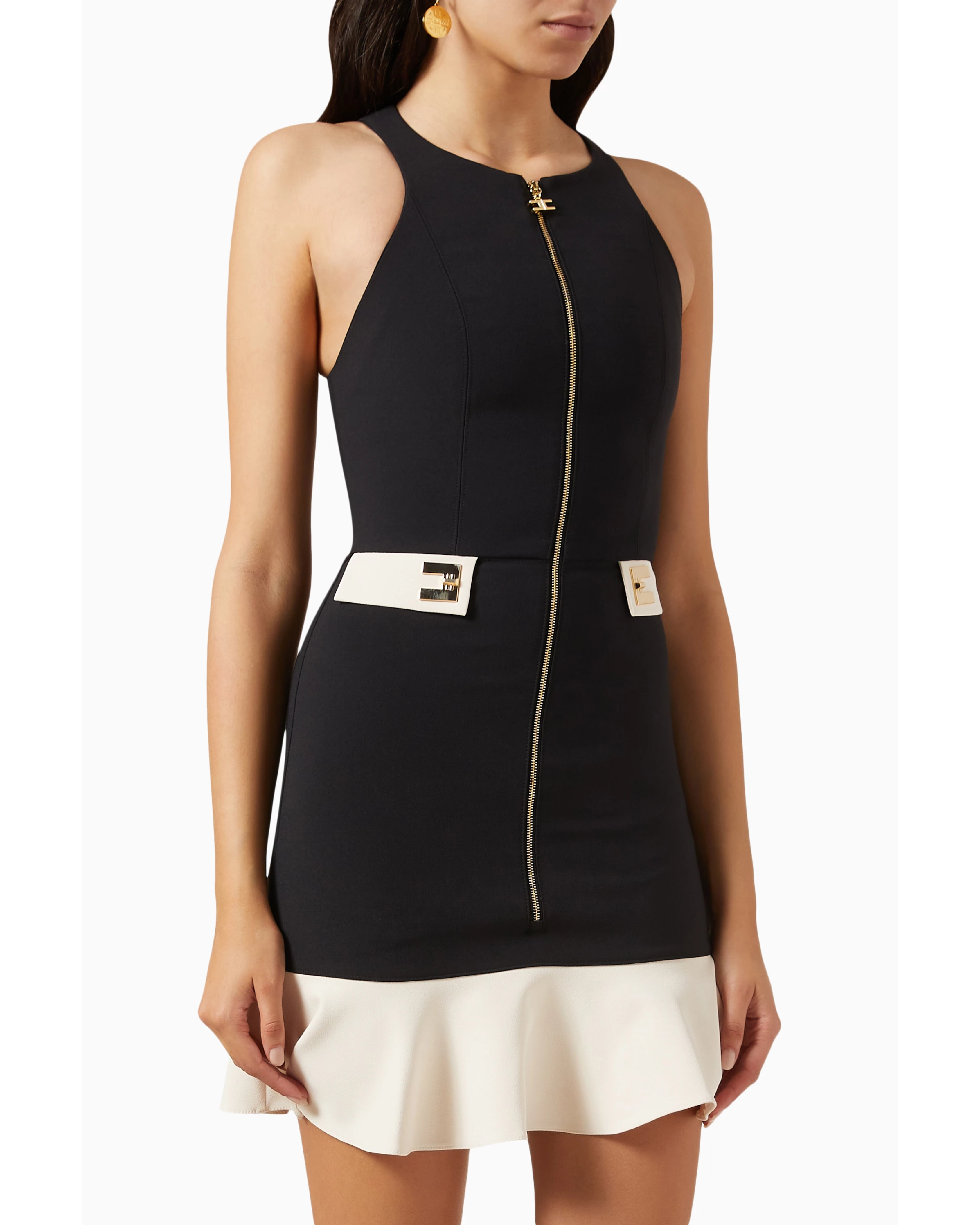 Woman wearing black and cream mini dress with gold turn-lock belt and chain shoulder bag — Elisabetta Franchi | Endless UAE