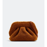 Gea Clutch in caramel brown textured fabric held in hand — TheMoire | Endless UAE