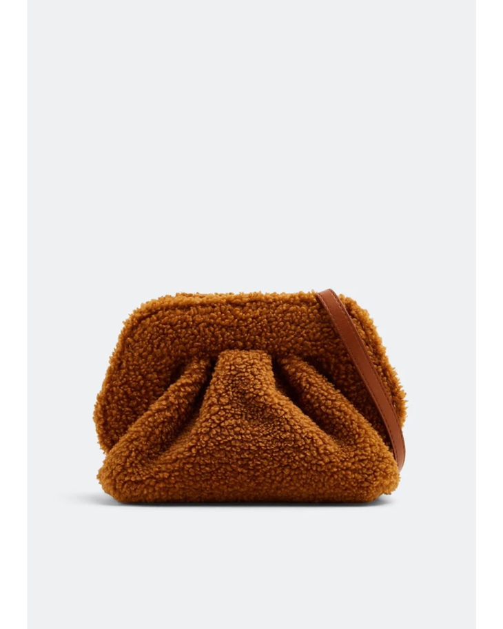 Gea Clutch in caramel brown textured fabric held in hand — TheMoire | Endless UAE